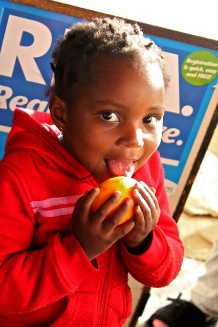 South African child licking citrus