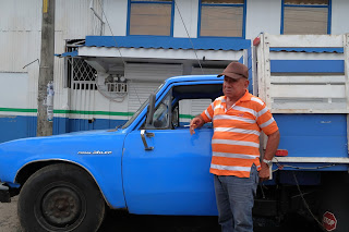 A man and his Nissan Miler truck in Puriscal