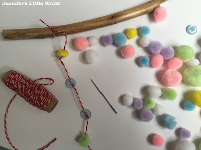 Making a simple stick mobile with buttons and pom poms