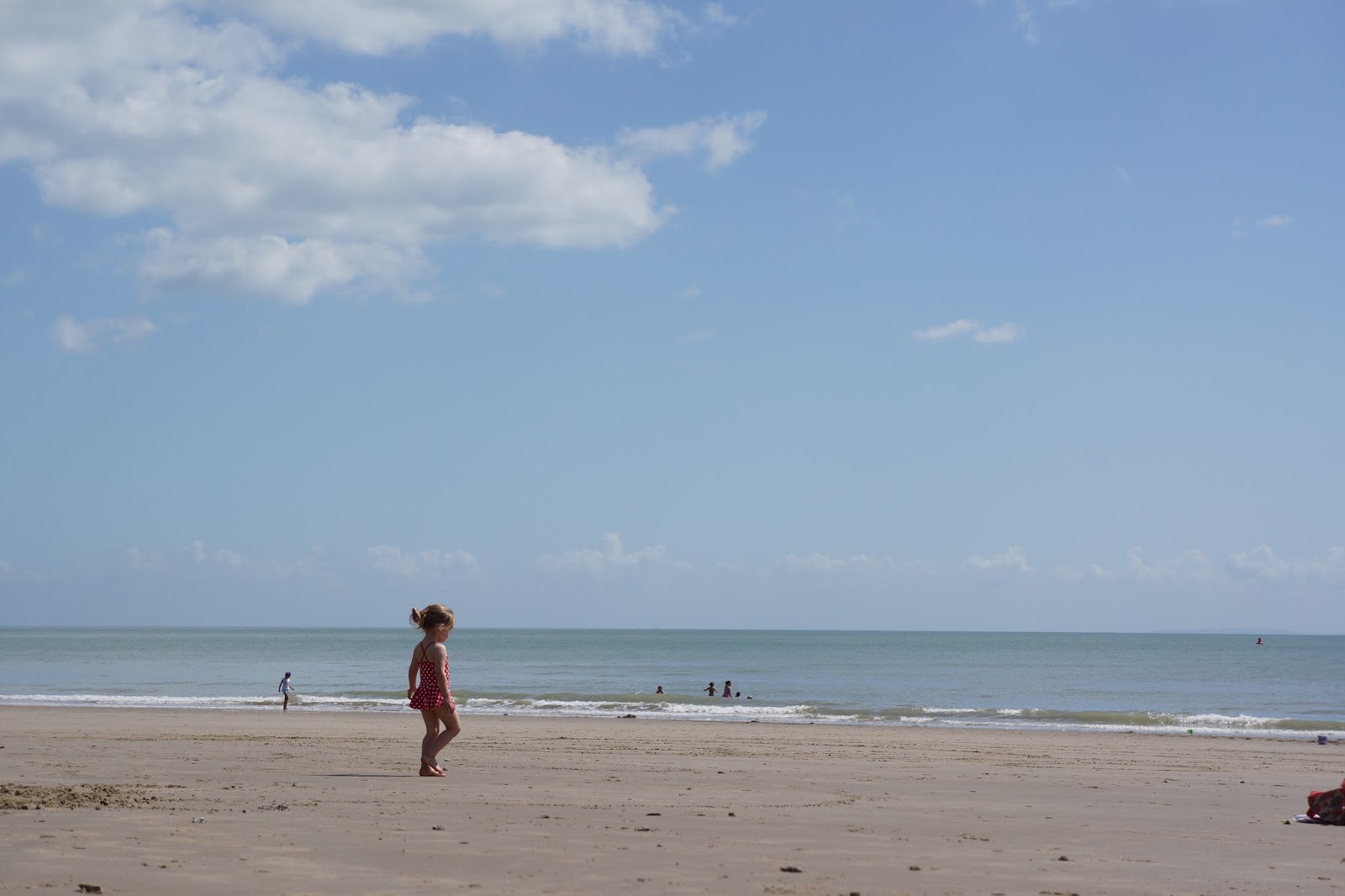 toddler walking on a sandy beach