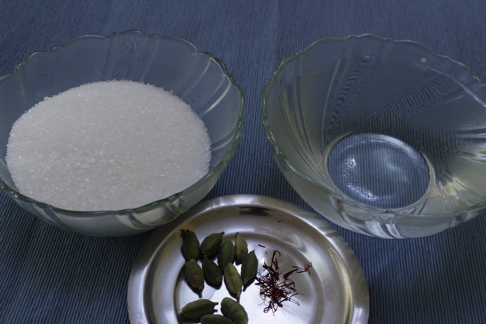 Close-up of perfectly golden Gulab Jamuns soaking in glistening syrup.