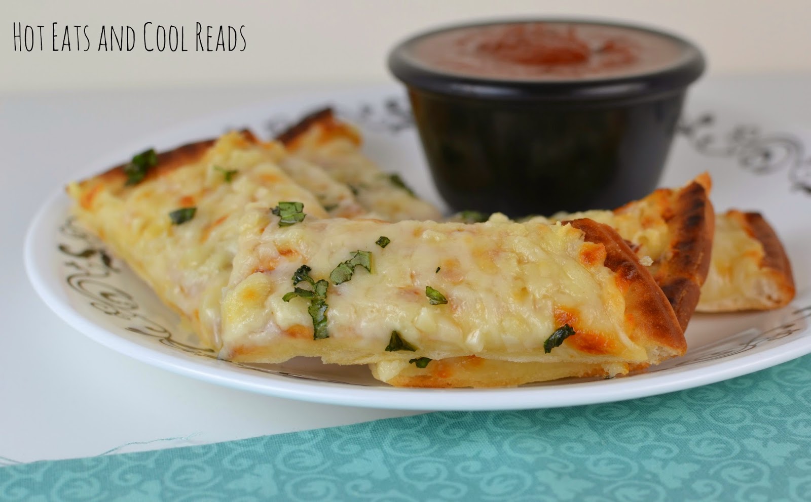 Garlicky, cheesy breadsticks that will satisfy any craving! Perfect as an appetizer or side, served with your favorite sauce! Cheesy Garlic Flatbread Breadsticks from Hot Eats and Cool Reads