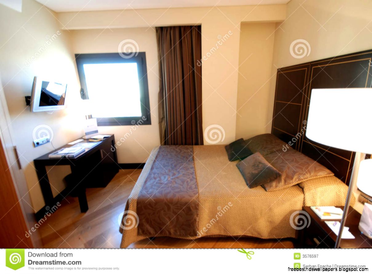 Modern hotel room with double bed decorated in shades of brown and