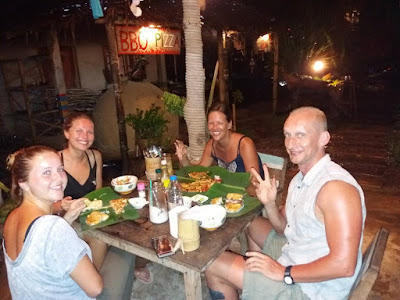 photo of Ellis and 3 other travellers having dinner from banana leafs