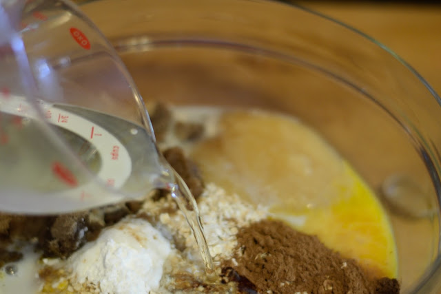 The oil being added to the mixing bowl of ingredients. 