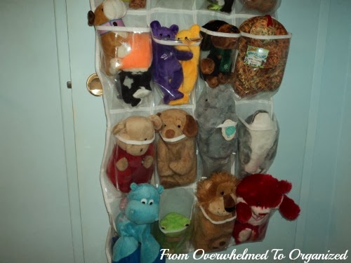 Overdoor shoe bag installed to hold stuffed animals.