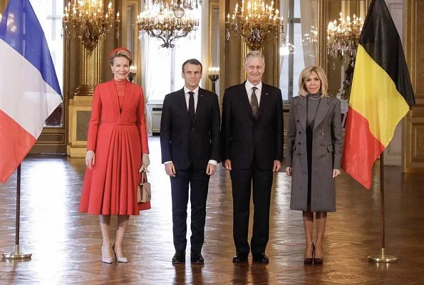 Queen Mathilde wearing a Christian Dior couture coat dress. Brigitte Macron wore Ralph Louren coat, dress and pumps