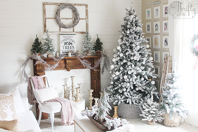 Christmas living room decor and decorating ideas. Farmhouse Christmas decor. Flocked Christmas trees. Shiplap wall and Christmas. Antique styled wood mantel. Wood mantel Christmas decor.