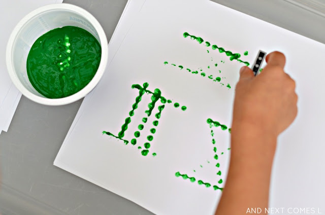 Learning about Roman numerals by stamping with LEGO - fun math art for kids from And Next Comes L