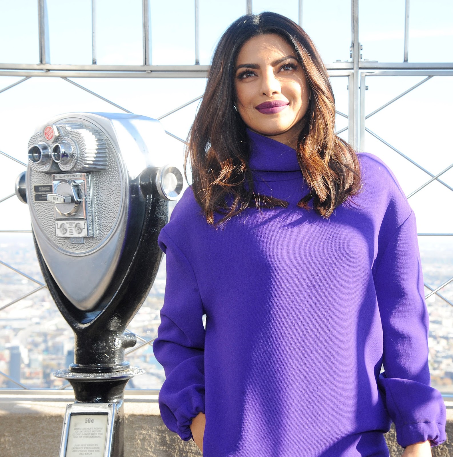 Priyanka Chopra Looks Sexy In a Purple Short Dress and Black Thigh High Boots During â€œQuanticoâ€ Promotion at The Empire State Building in New York City