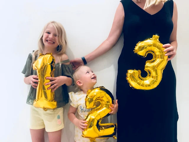 My pregnancy announcement for baby number 3 with numbered balloons