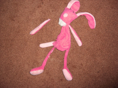 Picture of the bunny all ripped up, with her arm (that's not attached) laying beside her