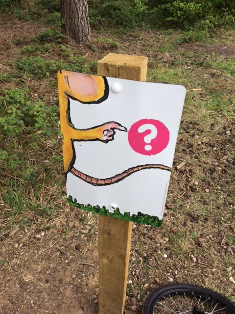 A sign showing part of a mouse pointing