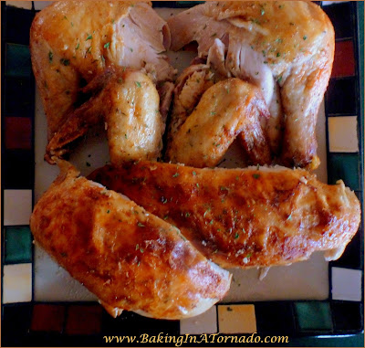 Oven Roasted Whole Chicken, seasoned, basted, and cooked to perfection. As moist and flavorful as a purchased rotisserie chicken at a much lower cost | recipe developed by www.BakingInATornado.com | #recipe #chicken #dinner