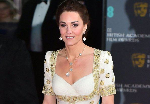 The Duchess wore a gown by Alexander McQueen. Jimmy Choo Romy gold pumps, She carries Anya Hindmarch gold glitter box clutch