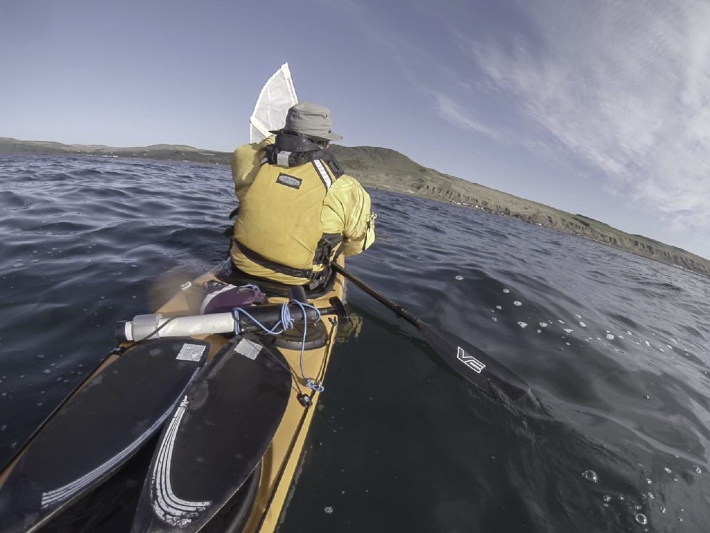 Sea kayaking with Assisted reentry after a capsize with a Flat Earth kayak sail.