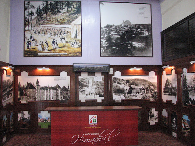 Shimla Heritage Museum: An eye opener for touristsVandana Bhagra, ShimlaPhotos: By me History can be interesting as well as inspiring and when coupled with life-size images it adds colour to ones imagination. And rather than leaving things to imagination the state tourism department has given shape to it in form of the recently inaugurated ‘Shimla Heritage Museum’ based on the concept of ‘har ghar kuch kehta hai’. Taking a step further this museum is housed in the 120 year old building which is prevalently known as the US Club dating back to almost 1860s, which has been renovated on similar line to the original structure to preserve its wholesomeness. As you enter the building you are reminded of Shimla down the years and a brief write up on the history of the United Service Club is good for enlightenment. The not so huge room inside, though just an attempt to capture the history of Shimla, holds nearly 50 huge portraits and sketches of Shimla dating to the Colonial period. Old timers can definitely associate with all the old building but the young and those visiting for the first time will be left mesmerizing with the beauty and legacy of Shimla. Some of the rare photographs adorning the walls include pictures of magnificent buildings such as the Viceregal Lodge, Rippon Hospital, Post Office, Town Hall, Gaiety Theatre, Combermere Bridge, Vidhan Sabha, Gorton Castle, Railway Board, Central Telegraph Office, the ARTRAC Complex and Barnes Court to name a few. Below the black and white sketches you can see the originals in coloured to give you a feel of the present day.  Dr Arun Sharma, Director Tourism and Civil Aviation says “Though at present we have very limited space, expansion plans are on anvil as and when we are provided with more space. An attempt has been made to re-discover Shimla's soul and through this museum we wish to fulfill the curiosity of the visitors. Heritage walks, timely tours, a training centre for tourists guides as well as related tourist activities would be taken up simultaneously”. He adds it is time that the heritage status of Shimla is used to maximize economical gains as well as use innovative methods to attract more and more tourist to the states and also prolong their stay. Sharma said, “The department has started the Shimla City Tour in association with the Tourism Industry Stakeholders Welfare Society, Shimla through which heritage walks would begin in the city”. Taking this concept further he says, “We are planning on adopting one village in each district which will be promoted as a tourist destination by opening similar kinds of museums eerywhere”.Surender Justa, District Tourism Development Officer, added that this is just a beginning of better things to come. “Initiatives are being taken to promote this museum as well as Shimla City as a heritage destination. Banners and signage’s are being put up on the streets to inform the tourist about this place. At the same time guides are being given training to help tourists. Despite the fact that it is just a one room museum, expansion plans are on”.In spite of the fact that this museum is a one room show but perceptions and insights will definitely change once you walk around. You may have heard stories about the old ‘tongas’, the ‘rikshaw’ or the styles and glory in which the Britishers lived, which you can easily picturize through the portraits and sketches placed here. A must stop over to complete your visit to Shimla and take some amazing memories.