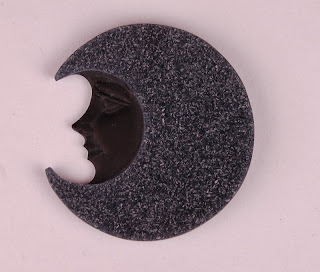Carved moon face in black agate with sparkly drusy