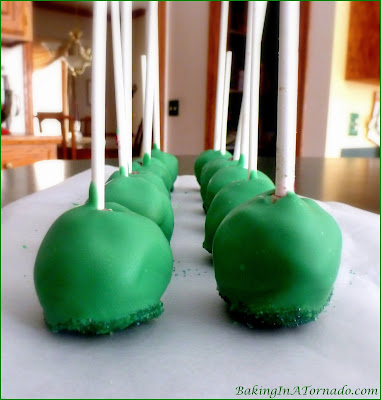 Chocolate Mint Cookie Pops, a no-bake treat. Mint cookie balls with a surprise inside. A fun dessert for St. Patrick’s Day or for any occasion | Recipe developed by www.BakingInATornado.com | #recipe #dessert #StPatricksDay