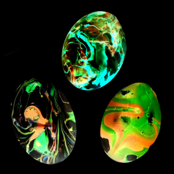 Decorate Easter eggs that GLOW with this easy nail polish marbling technique.  Kids won't believe their eyes as they dye swirling, neon Easter eggs! #marbledeastereggs #marbledeggs #marbleizedeggs #nailpolisheastereggs #nailpolisheggdecorating #glowingeggs #gloweggs #growingajeweledrose