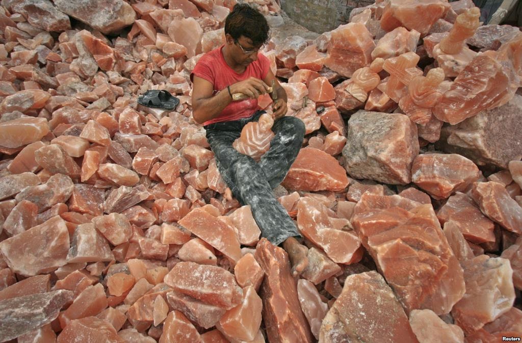 A man in Lahore applies the final touches to a sculpture made from rock salt. -5 Best Places To Discover In Pakistan A man in Lahore applies the final touches to a sculpture made from rock salt. 5 Best Places To Discover In Pakistan