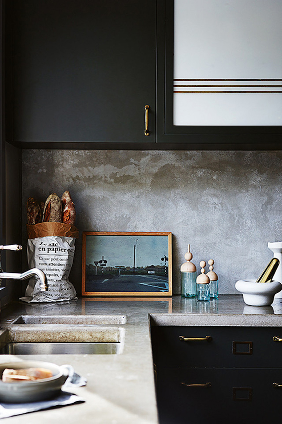 Kitchen with concrete countertop and splashback. Photo  by Anson Smart, styling by Claire Delmar for Inside Out Magazine