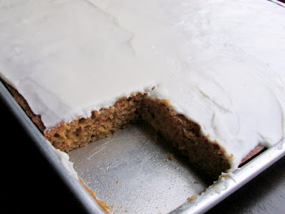 Soft and simple pumpkin cake topped with cream cheese frosting, you may know them as pumpkin bars or pumpkin squares. Either way, these are the things fall dreams are made of! A perennial family favorite. half sheet pan of pumpkin bars with corner piece missing