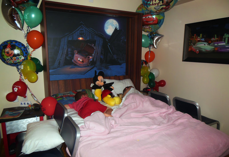 This is the bed pulled down and the boys snuggled down for the night.  The picture of Mater above their heads was complete with a built in night light in the form of the moon and the light above Mater on the barn.  A dimmer switch controlled how bright the lights in the picture got.  Seriously?  Genius again.