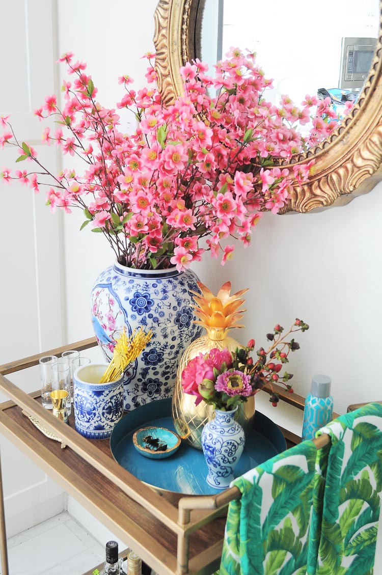 A blue and white with florals chinoiserie and ginger jar inspired bar cart styled for summer soirees and entertaining. So many decor ideas!
