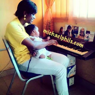 mother playing way maker by sinach on the keyboard