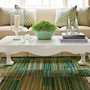 This modern coffee table compliments the glass vase and candle decor piece.