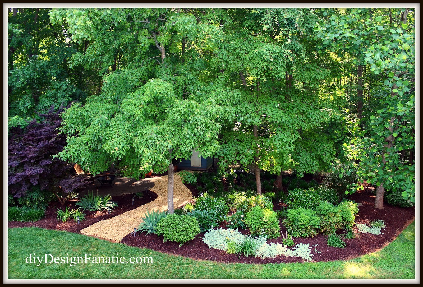 you can see the garden path leading down to the patio in the woods and