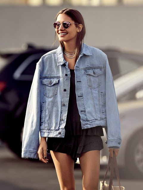 Street style | Denim jacket, ruffling romper and round sunglasses ...