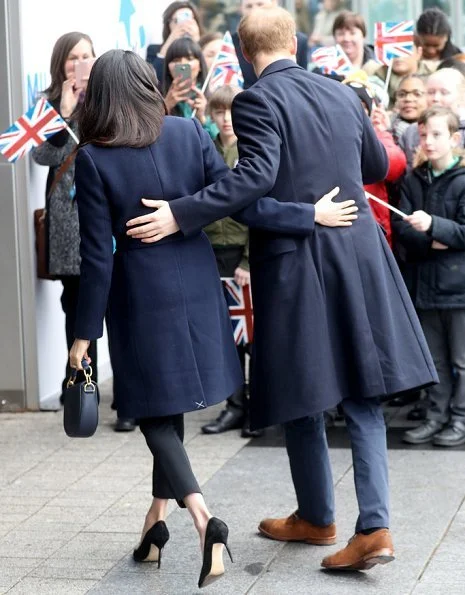 Meghan Markle wore J.Crew coat, Manolo Blahnik pumps, All Saints Ridley jumper, Alexander Wang Pants and carried Altuzarra Ghianda shoulder bag