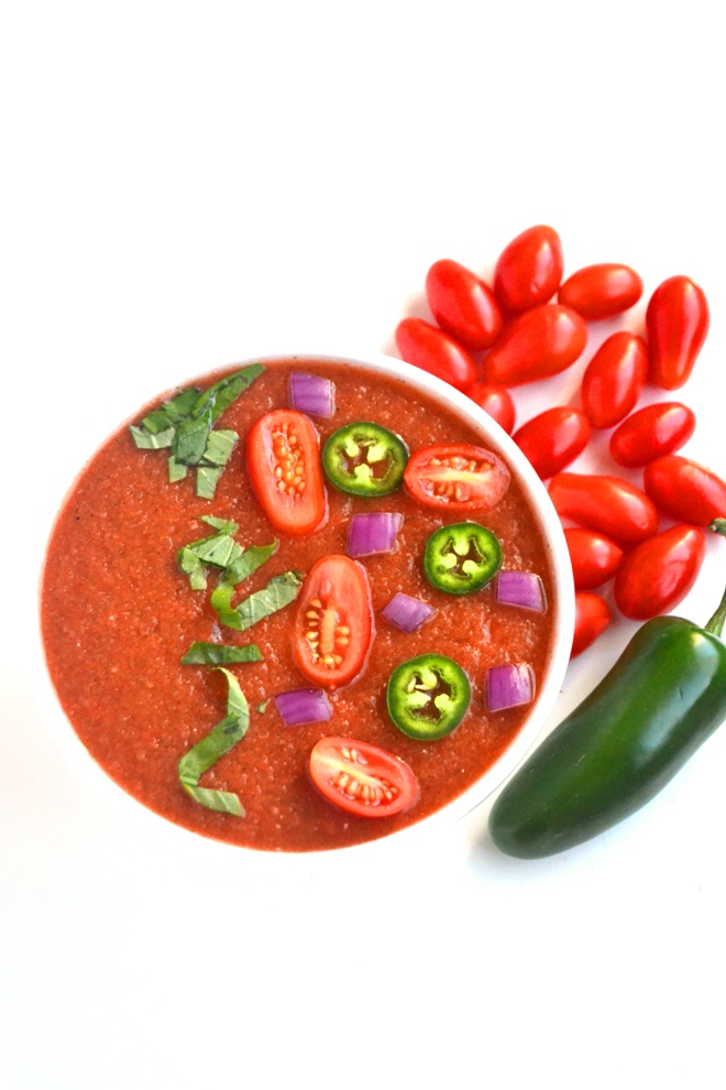 Spicy Gazpacho Soup takes 10 minutes to make and is full of flavor with fresh jalapenos, tomatoes, cucumber, onion, bell peppers and basil for a light and fresh meal! www.nutritionistreviews.com