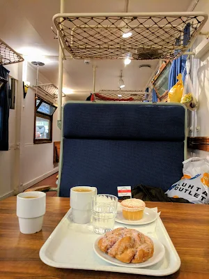 Cake and a bun served in an old train car inside Turku Market Hall on a Finland road trip
