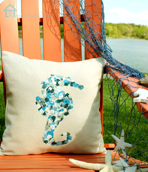 Adirondack orange chair with pillow by a lake