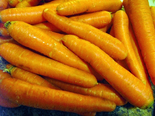 Carrots, cleaned and without tops, ready to be chopped and pressure-canned.