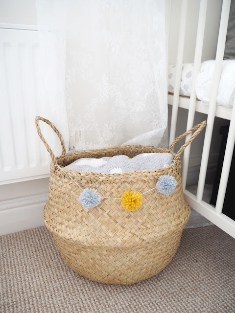 DIY tutorial to make a wool pom pom garland on belly basket for £10. Summer interior trend and storage solution you can craft and create yourself on a tight budget