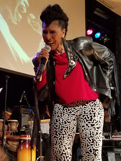 Nona Hendryx wore a black leather jacket and bell-bottom print pants.