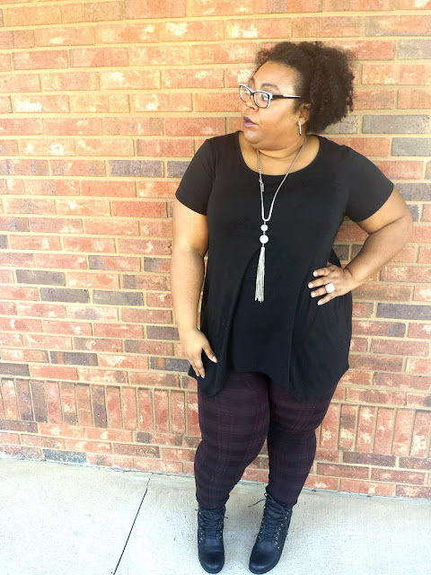 Black tunic, glam goth, printed leggings, black lace up booties, long tassel necklace, afro hairstyle