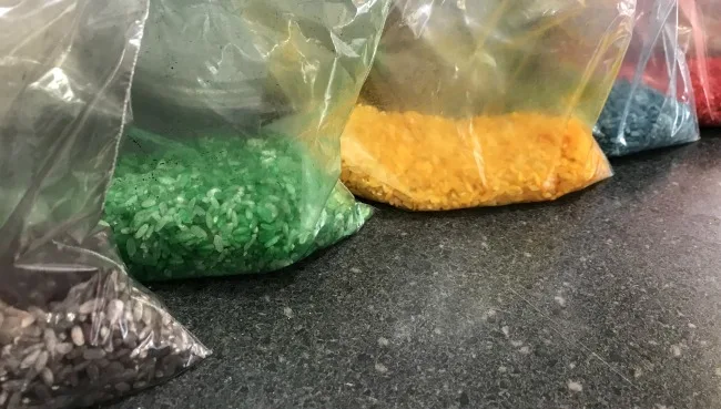Bags of different colored rice