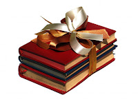 stack of books tied with a golden bow