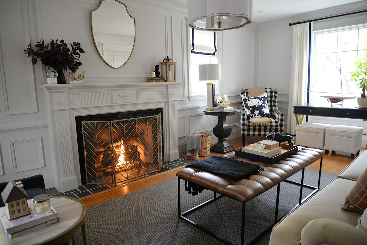 A HomePop brown tufted ottoman brings masculine cozy style to a traditional living room