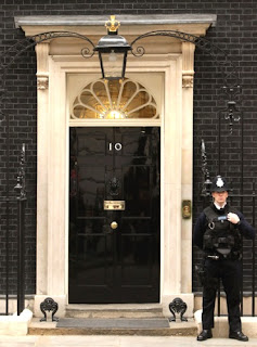 Police officer standing guard at the main doorway of Number 10
