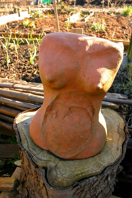 Garden decor with found objects: clay torso