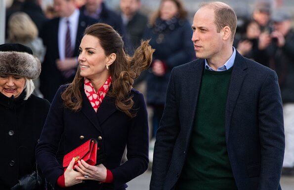 Kate Middleton wore a new navy coat by Hobbs London, and a new knitted puff-sleeve midi dress by Zara. Beulah London Kamala scarf