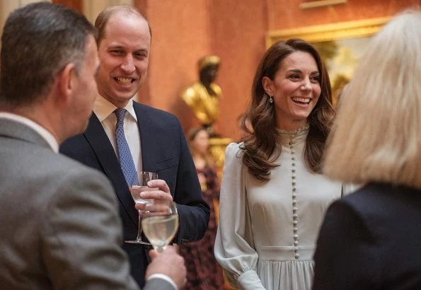 Kate Middleton is wearing a midi dress with ruffle detail