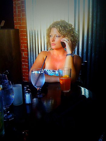 woman drinking at bar alone