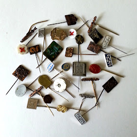 Selection of vintage enamelled tie pins in various shapes and colours.